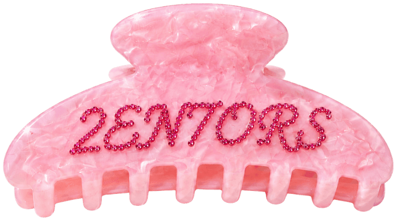 The 2EN7ORS claw clip in rose quartz marble, beaded lettering across the face.