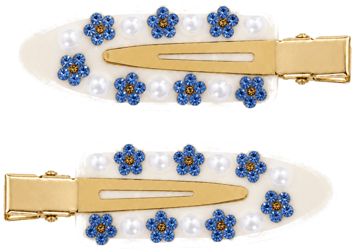 A pair of Daisy clips in ivory, set with blue flowers and round white beads.